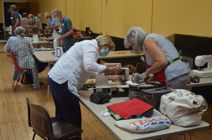 Repair Café Havant volunteers helping with sewing machine repairs at a community session in 2021